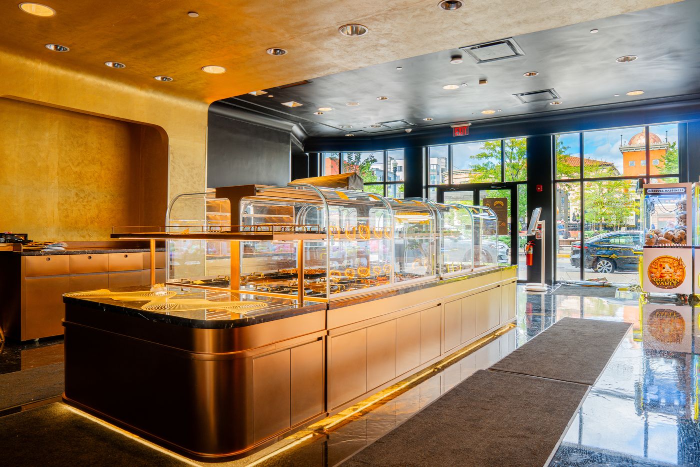 Pastry display counter under a gold ceiling